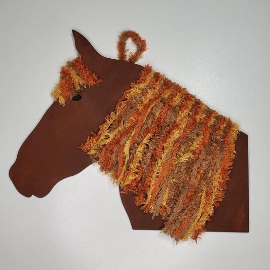 A laser cut wood horse head hand painted with yarn for the hair and ready to hang