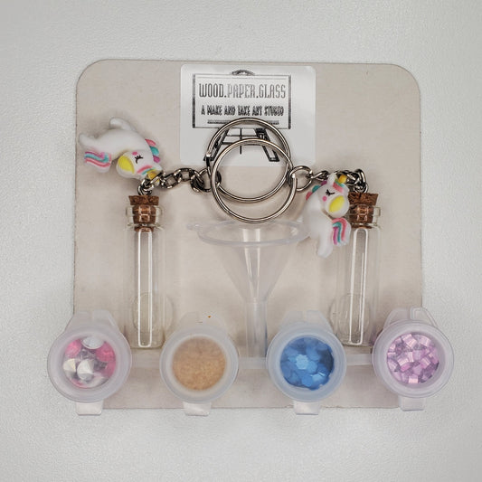A colorful DIY keychain craft kit with unicorn charms and a funnel to use with fillers to fill the keychain bottle.