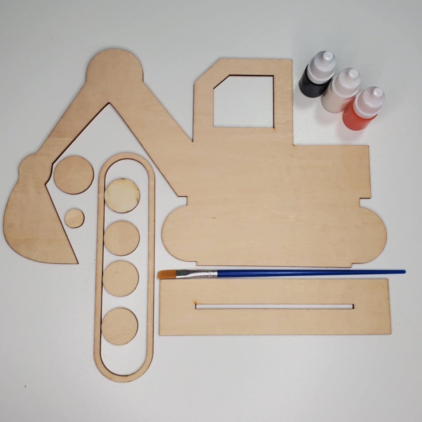 A laser cut wood excavator DIY KIT ready to be hand painted. Paint, paintbrush, paint and glue included.