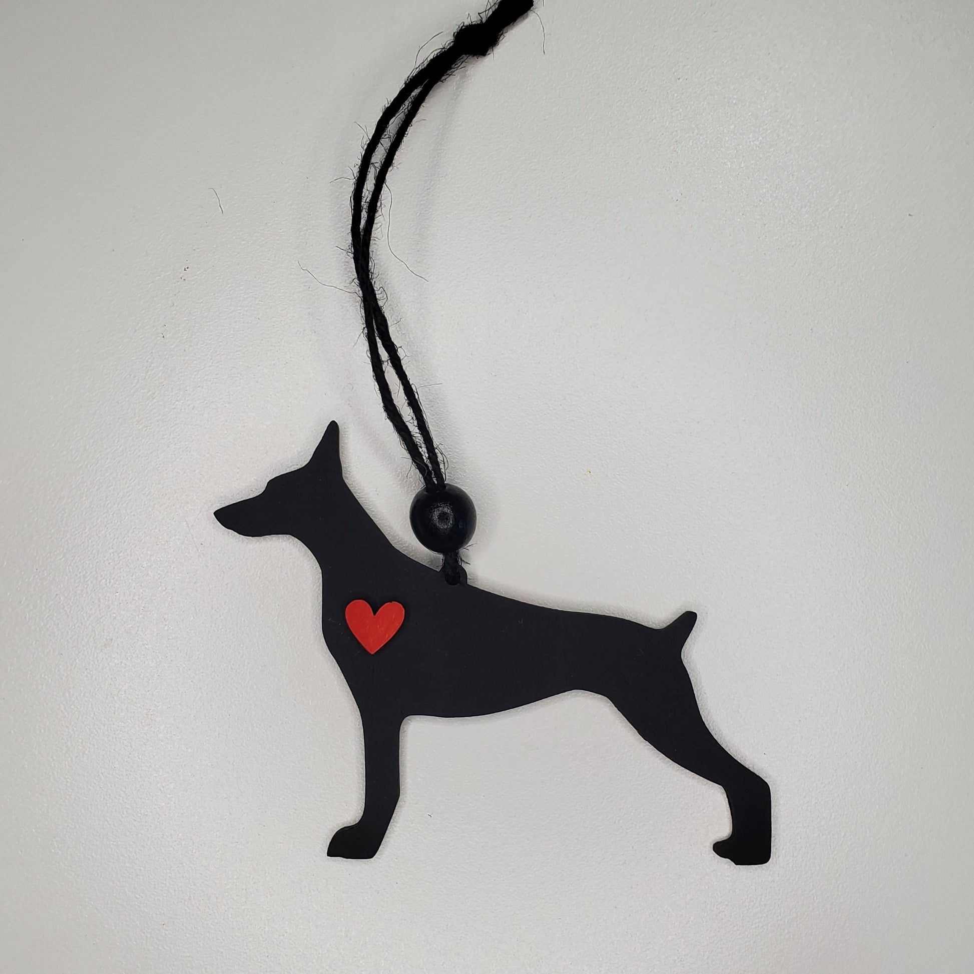Laser cut wood ornament, car charm shaped Doberman hand painted in Tricorn Black adorned with a heart.