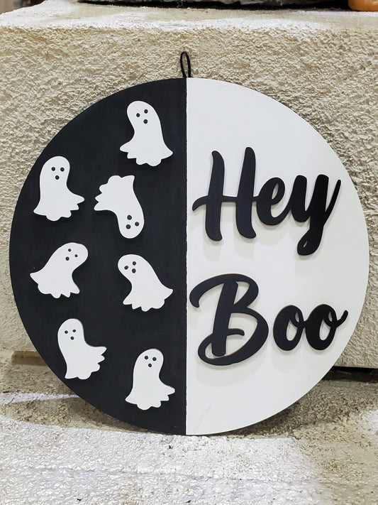Halloween-themed circular sign with ghosts and 'Hey Boo' text on a door round t o be hung or displayed