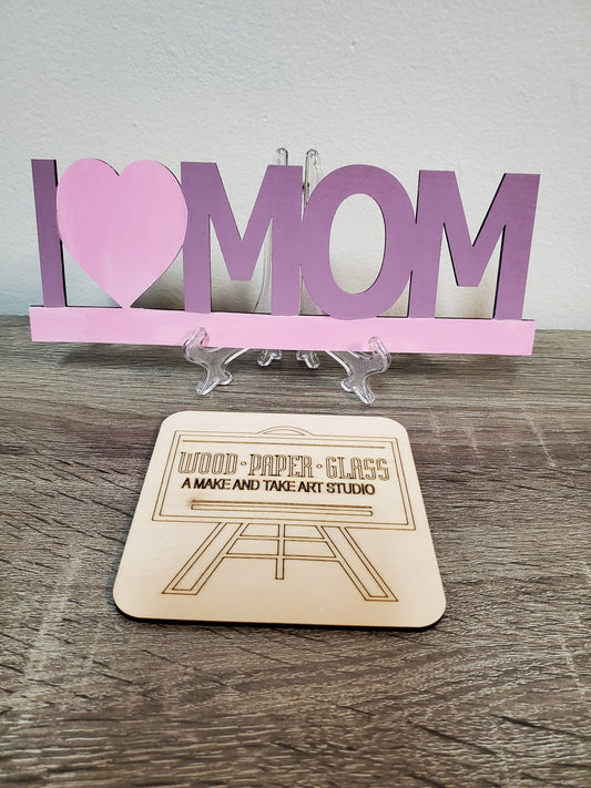 Laser cut wood hand painted I love mom sign with rhinestone embellishments.