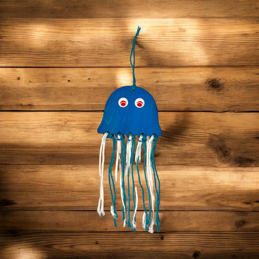 Squid DIY Craft Kit - Lifestyle
Laser cut wood squid hand painted blue with wiggly eyes and blue and white yarn.