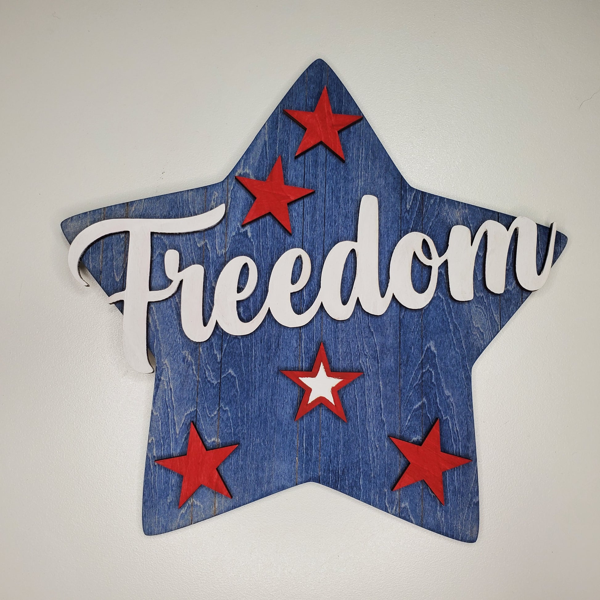 Star-shaped sign with 'Freedom' text and red stars on a white background