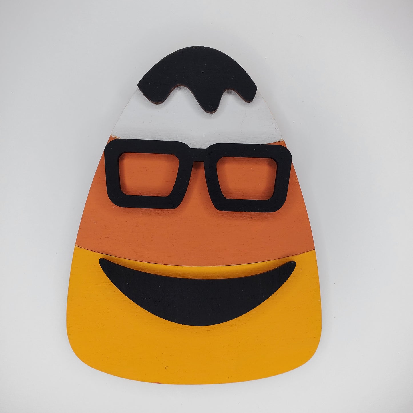 White, Orange, and Yellow candy corn shaped wooden piece with glasses and smile. DIY or Finished piece available
