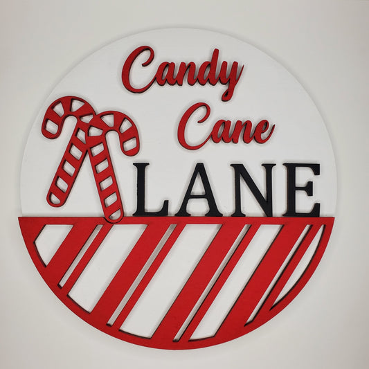 Decorative sign with 'Candy Cane Lane' text and candy cane design on a white background. Finished or DIY available