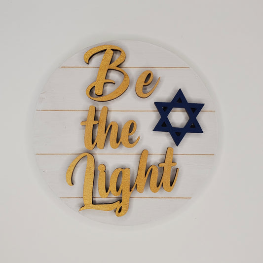 Words "Be The Light" On a White Wooden Background with a Star of David