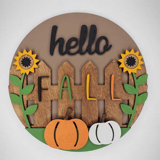 Decorative wall art with 'hello Fall' text and autumn elements on a door round. Easy to hang or display.
