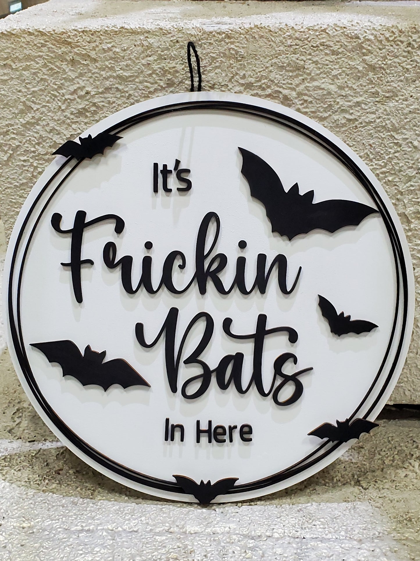 Decorative sign with 'It's Frickin Bats In Here' text and bat illustrations on a door round to hang or display. Available in finished or unfinished DIY  kit.
