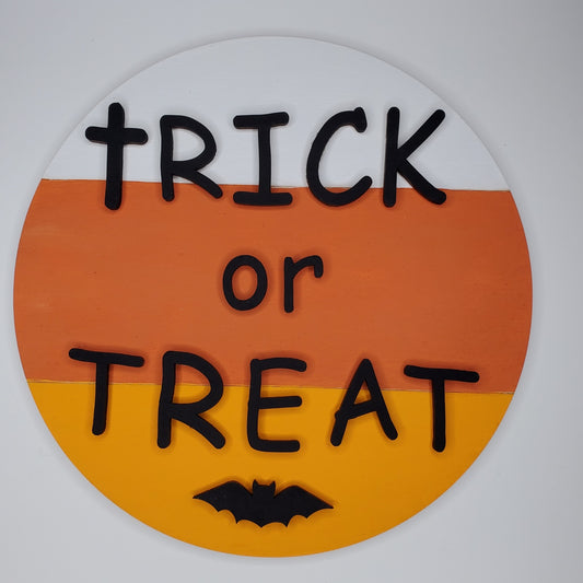 Halloween-themed sign with 'TRICK or TREAT' text on a white, orange, and yellow background. Door round or shelf leaner. Sizes 7inch, 12 inch or 16 inch. DIY kit available.