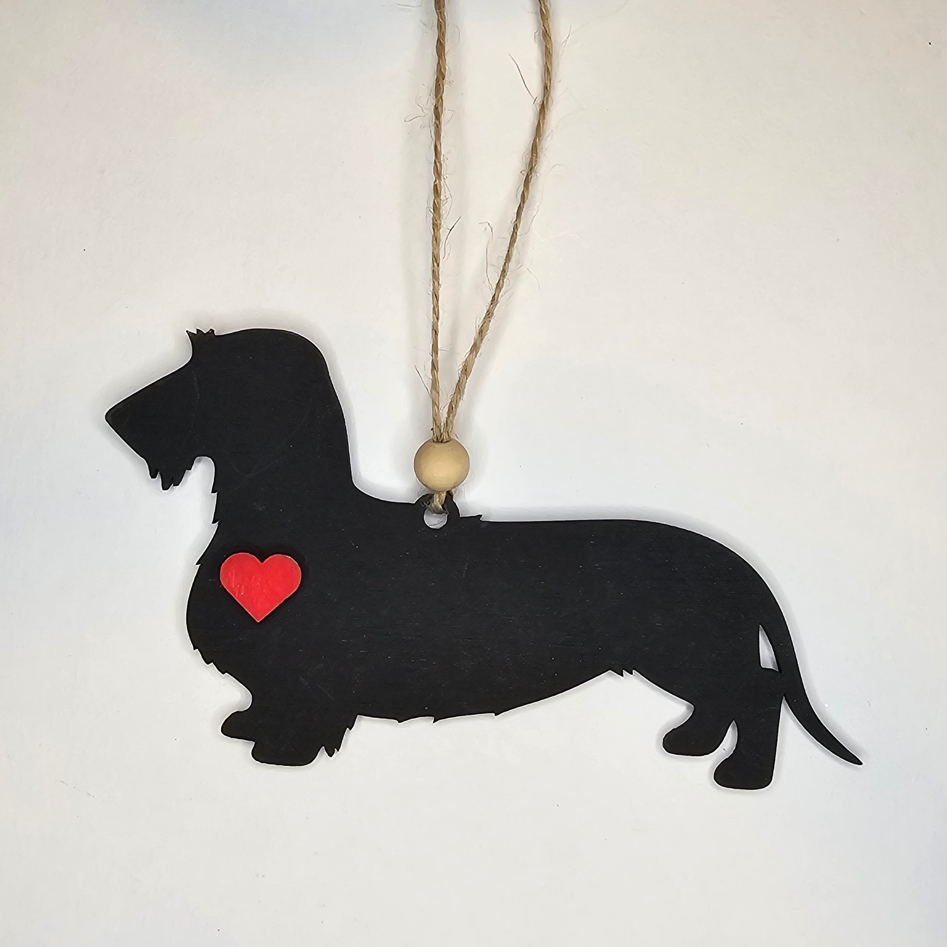 Black dog-shaped ornament with a red heart Wired Dachshund.
